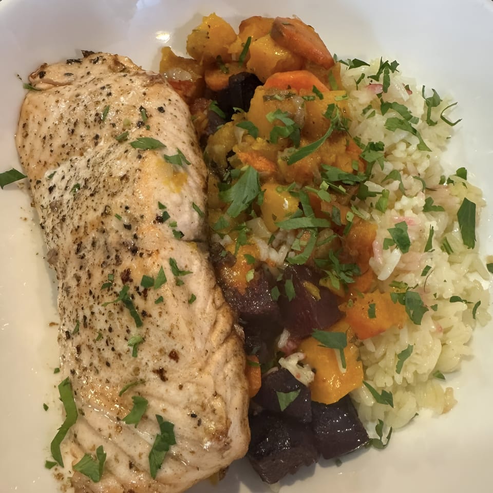 Mambo Italiano's chicken with roasted vegetables and rice, garnished with fresh parsley.